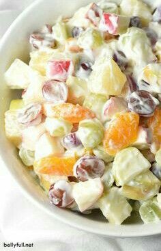 a white bowl filled with fruit salad on top of a table