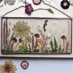 an art piece with flowers and plants in it