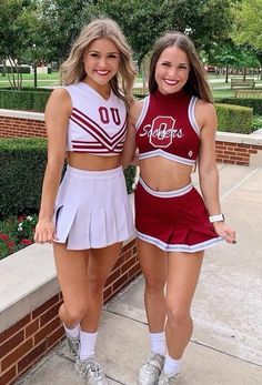 two cheerleaders standing next to each other