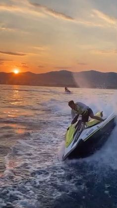 a man riding on the back of a jet ski while being pulled by a boat