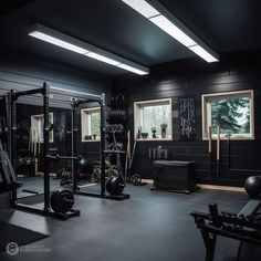 an empty gym with black walls and equipment