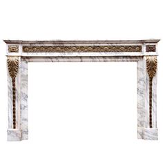 a white marble fireplace mantel with an intricately carved design on the top and sides