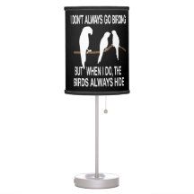 a lamp that is on top of a white base and has two birds on it with the words, don't always go behind but when do the birds always lie