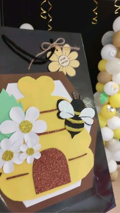 a close up of a bag on a table with balloons and flowers in the background