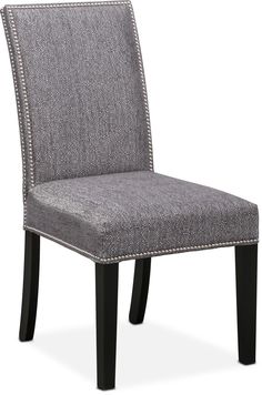 a gray upholstered chair with studded trimmings on the back and legs