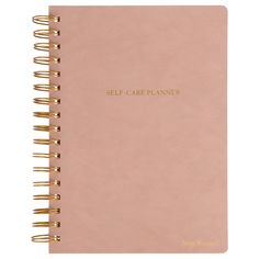 a pink self care planner with gold writing on the front and back cover, featuring two spiral