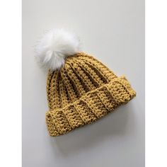 a knitted hat with a white pom - pom on top