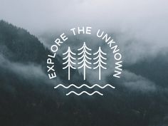 the words explore the unknown are written in white on a dark background with mountains and fog