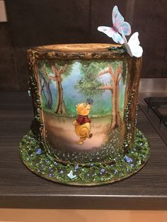 a winnie the pooh birthday cake on a table