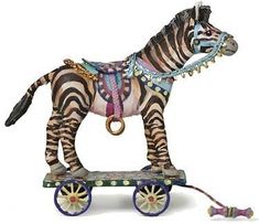 a zebra figurine is sitting on top of a small cart with wheels and beads