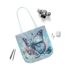 Artwork Tote 'Sky Blue Wings', Butterfly Tote Bag, Light Blue Tote Bag, Light Blue Tote, Butterfly Tote, Beach Tote Bag, Gifts Under 20 Lightweight and durable, this beautiful all-over printed artwork tote bag does it all. The inside has a sleek, black lining and its comfortable straps come in five color choices. Choose any (or all) of the three sizes--for quick errands, shopping trips, and longer travels. The latest printing techniques provide bright and crisp colors and fine details. Created from my abstract artwork, 'Sky Blue Wings'. * 100% Polyester canvas -- fine weave texture fabric and soft foamed lining makes wearing super comfortable * All over artwork print * Available in 3 sizes * Black interior * Boxed corners -- front and back sides are sewn together by creating extra space on Light Blue Rectangular Shoulder Bag As Gift, Artistic Blue Shoulder Bag For Everyday Use, Artistic Blue Bag For Everyday Use, Blue Handmade Bags As Gifts, Light Blue Rectangular Shoulder Bag For Gift, Handmade Blue Bags For Gifts, Blue Shoulder Bag For Gift, Handmade Blue Bags As Gifts, Handmade Blue Shoulder Bag For Travel