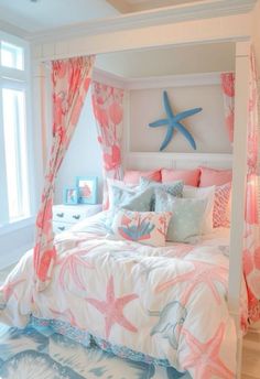 a bedroom with pink and blue bedding, starfish pillows, and drapes