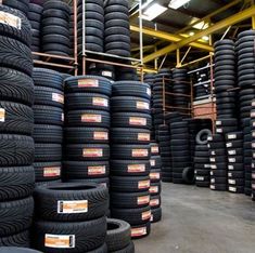 many tires are stacked up in a warehouse