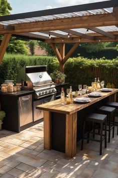 an outdoor kitchen with grill, table and barbeque set up for two people