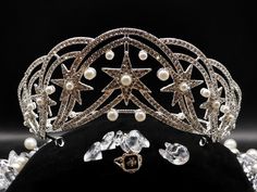 The Hesse Star Tiara comes from the Greece and Denmark dynasty, worn most notably Grand Duchess Cecilie. This gorgeous piece is an almost exact replica of the original created in 1931. Featuring 9 stars, scattered faux pearls and 100s of glittering rhinestones. At it's peak it measures 3 inches and is 7 inches wide at its mid point. This is a collector's dream piece.  All tiaras are present in a velvet dust bag with rhinestone keepsake pin nestled in a bed of protective paper shred in a collector box. We ship our tiaras with extra padding and care to make sure it arrives in pristine condition. Star Tiara, Blue Wedding Guest Dresses, Alexandra Of Denmark, Royal Crown Jewels, Pageant Crowns, Headpiece Jewelry, Future Wedding Plans, Overland Park, Crown Jewels