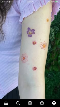 a woman's arm with flowers on it