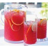 two pitchers filled with watermelon and orange slices