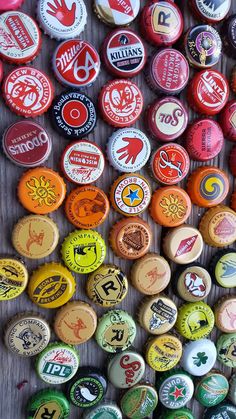 many different colored buttons on a wooden surface