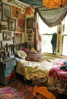 a bed room with a neatly made bed and lots of pictures on the wall