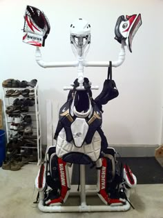 an inflatable hockey goalie's helmet and gloves are displayed on a stand