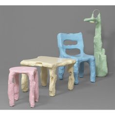 three different colored plastic chairs and tables