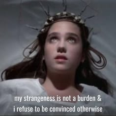 a woman with long hair wearing a crown on top of her head and the words, my strangeness is not a burden & i refuse to be convened otherwise