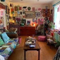 a living room filled with furniture and lots of pictures on the wall above it's windows