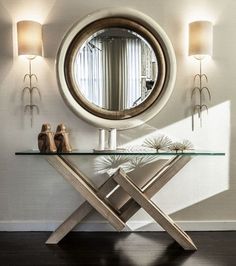 a glass table topped with a round mirror