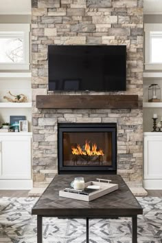 a living room with a fireplace and tv above it