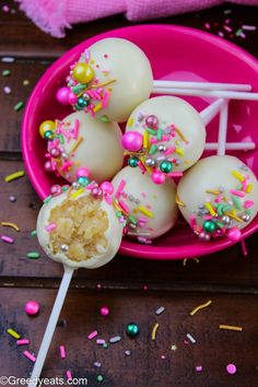 vanilla cake pops with sprinkles on a pink plate