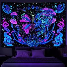 a bed with purple and blue decorations on the headboard, in front of a black background