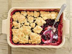 blueberry cobbler in a baking dish with a spoon