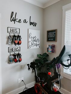 a bike is parked in front of a wall with shoes hanging on it's hooks