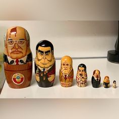 a group of russian nesting dolls sitting on top of a white counter next to each other