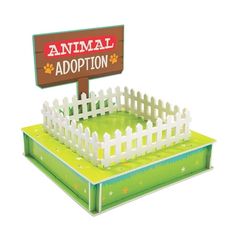 an animal adoption sign in front of a white picket fence