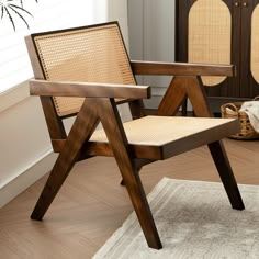 a wooden chair sitting on top of a rug in a living room next to a window