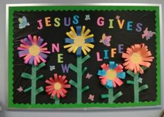 a bulletin board with paper flowers and butterflies on it that says jesus gives one life