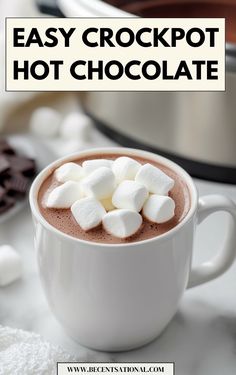 hot chocolate in a mug with marshmallows on top and the words easy crockpot hot chocolate above it