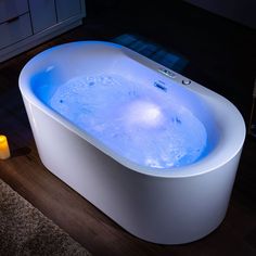 an illuminated bathtub in the middle of a room