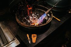 a large pot on top of a stove next to tongs