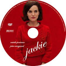 a woman wearing a red sweater is standing in front of a dvd disc with the words jakie on it