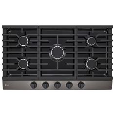 a black gas stove top with four burners