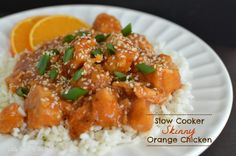 a white plate topped with rice covered in sauce and orange wedges next to an orange slice