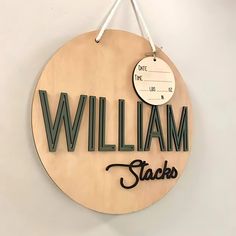 a wooden sign hanging on the wall that says william staces with a clock