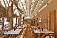 the interior of a restaurant with wooden tables and chairs