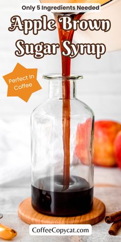 an apple brown sugar syrup being poured into a glass jar