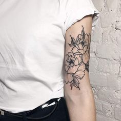 a woman with a flower tattoo on her arm