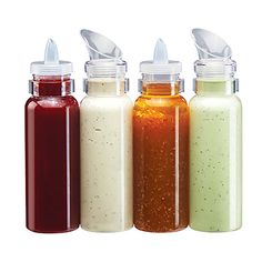 three bottles with different colored liquids in them