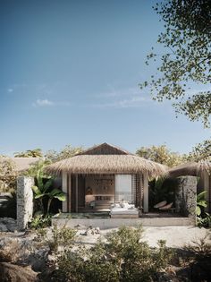 a house with thatched roof and palm trees around it, surrounded by greenery