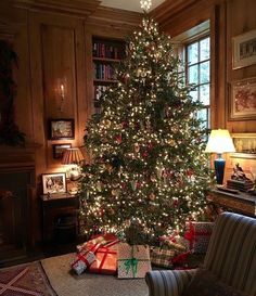 a christmas tree is lit up in the living room